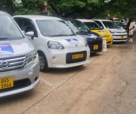 Businessperson working on laptop in a luxury car